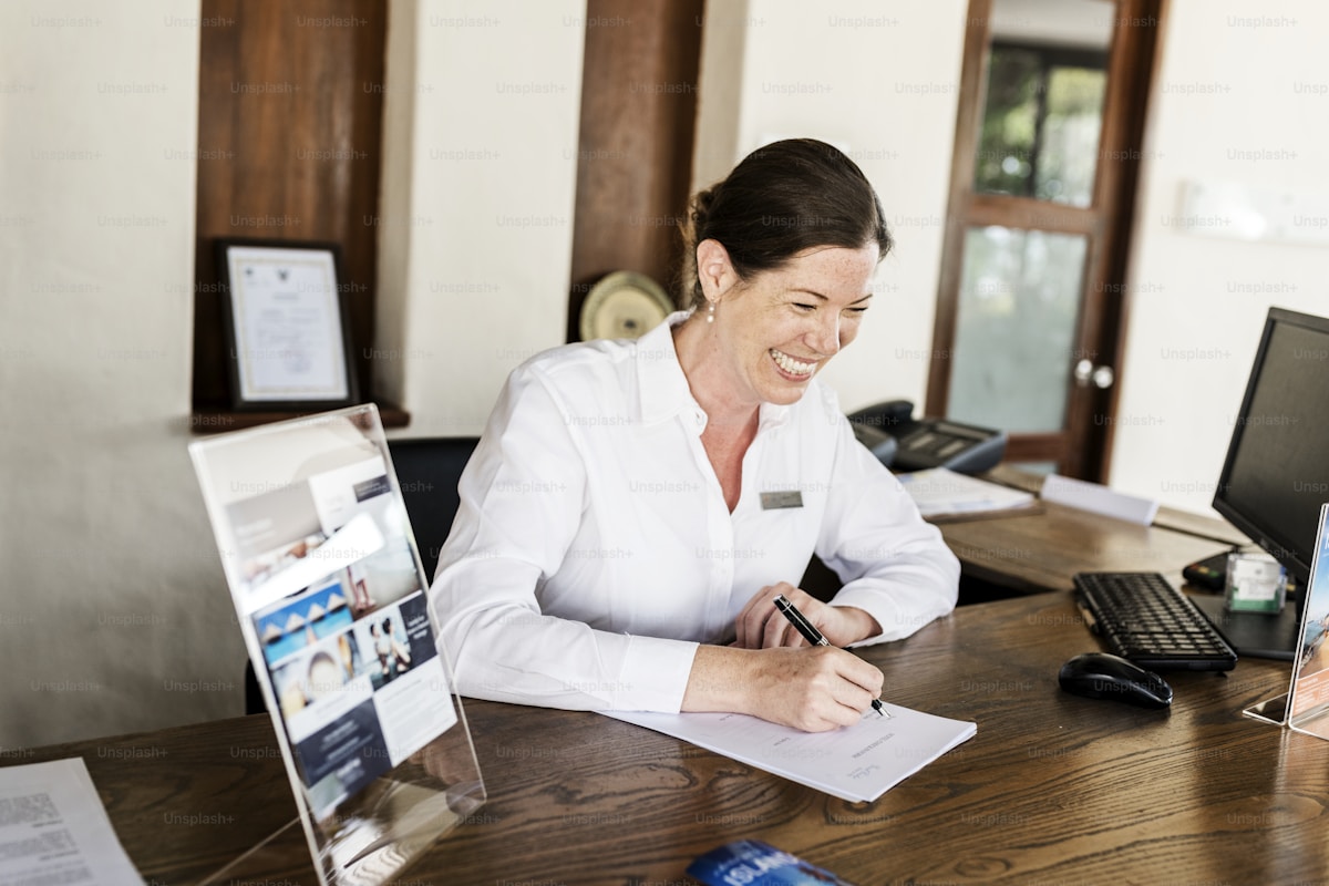 A hotel operations team reviewing connected systems at a modern front office — the integration layer that lets hotel AI actually work