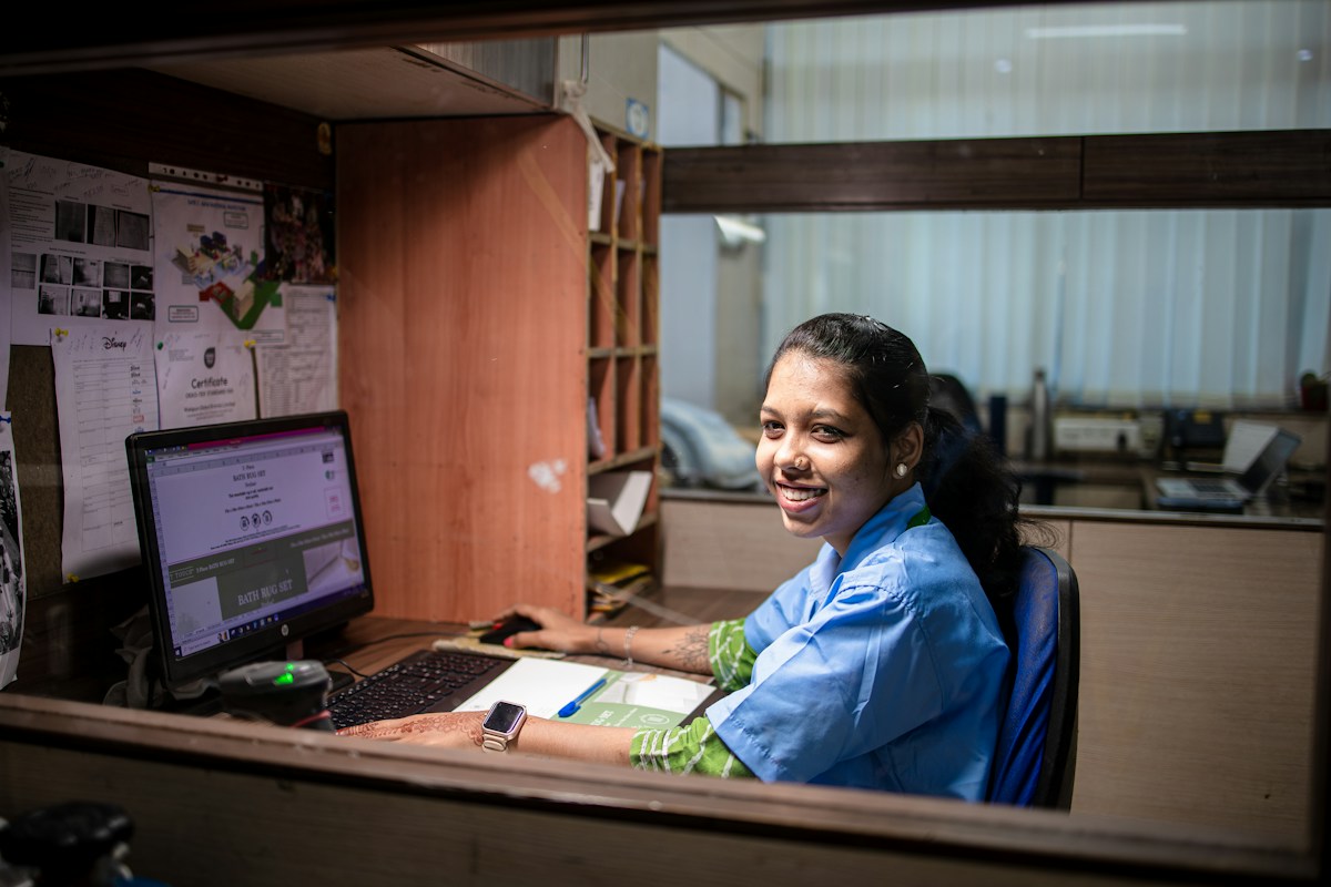 A hotel staff member working at a desk, the front line that depends on fast, correct answers